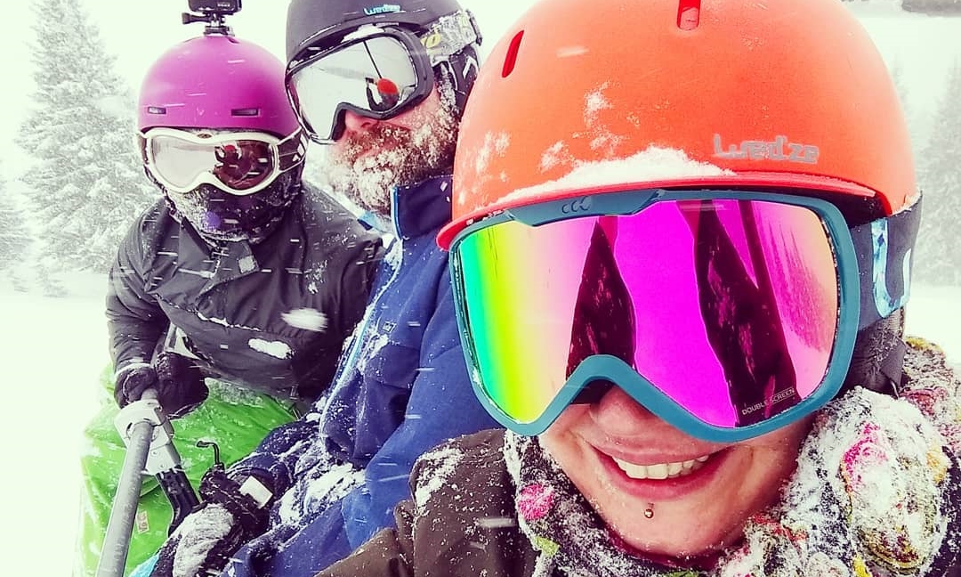 smiley mountain utopia team with snow covered faces on the chairlift in morzine