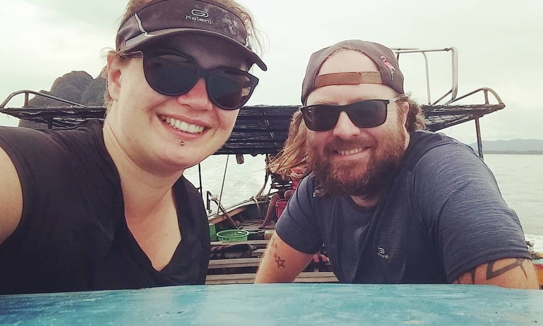 tamara and toby smiling on a boat traveling thailand